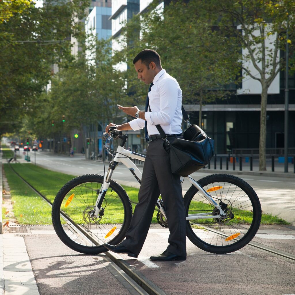 hispanic-office-worker-with-bike-phone-street